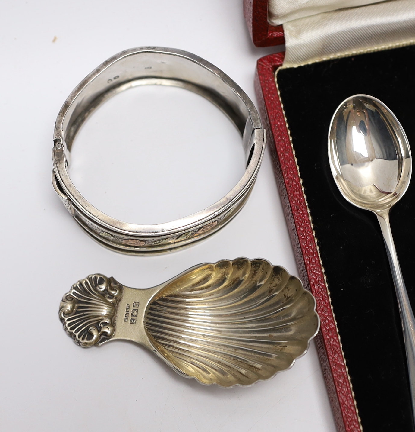 A modern silver caddy spoon, a small Edwardian silver mounted trinket box, a silver vesta case, a Victorian silver bangle and a 925 bangle and a cased set of six silver 'Hallmark' spoons.